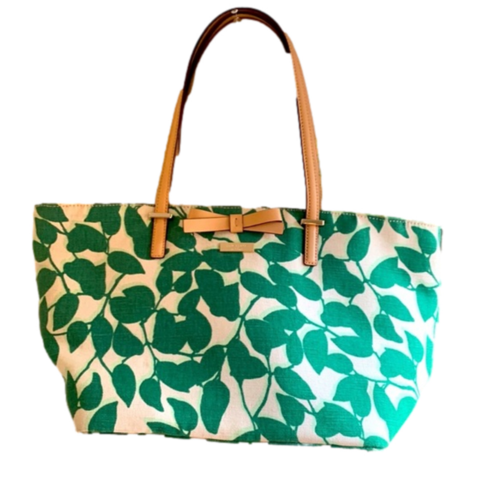 Kate Spade cream colored cloth tote with green leaf pattern.